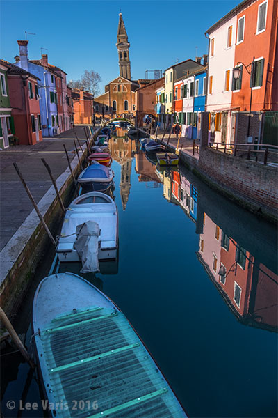 Here the blue channel luminosity is applied to the image through a soft edged mask to lighten the boats.